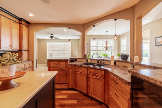 60515 235th St, Madison Lake, MN 56063 - kitchen featuring wine cooler, a ceiling fan, decorative light fixtures, brown cabinets, and recessed lighting
