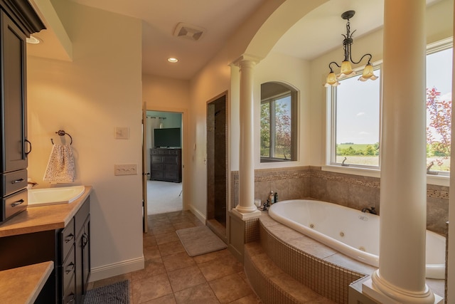 60515 235th St, Madison Lake, MN 56063 - bathroom featuring ornate columns, a jetted tub, vanity, tile patterned flooring, and recessed lighting