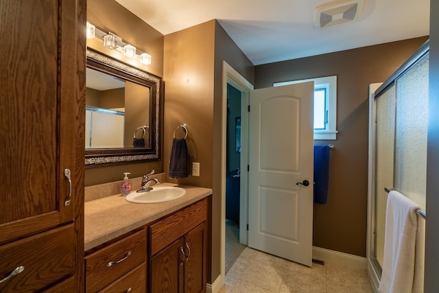 60515 235th St, Madison Lake, MN 56063 - full bath with vanity, a shower stall, and tile patterned floors