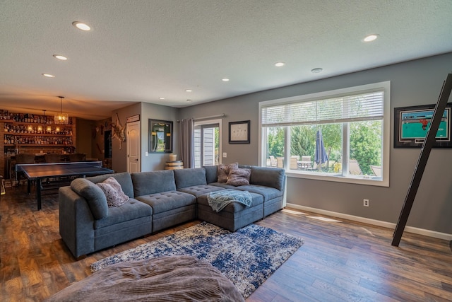 60515 235th St, Madison Lake, MN 56063 - living room featuring a textured ceiling, bar, wood finished floors, and recessed lighting