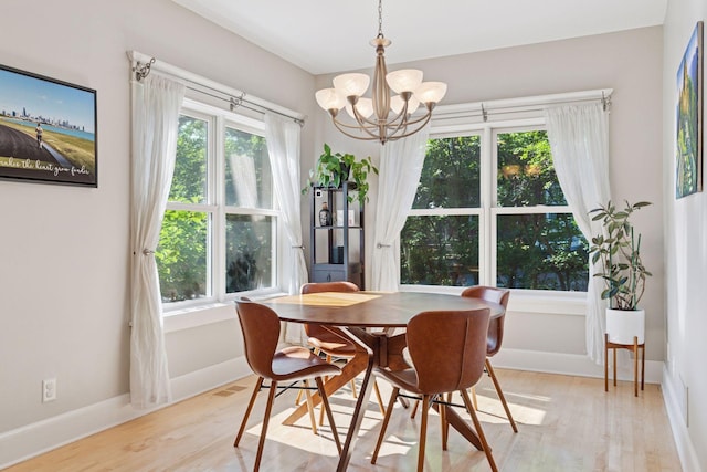 4312 France Ave S, Edina, MN 55410 - dining room with a chandelier, light wood finished floors, and plenty of natural light