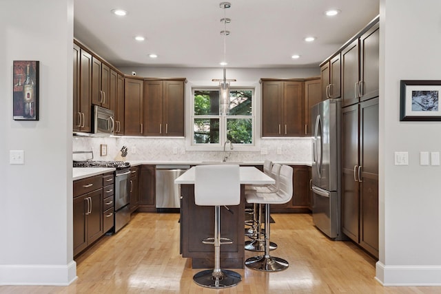 4312 France Ave S, Edina, MN 55410 - kitchen featuring stainless steel appliances, light wood-style flooring, recessed lighting, and backsplash