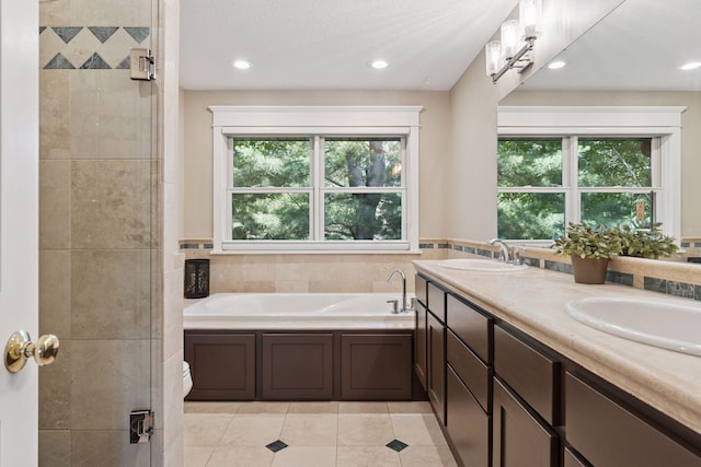 4312 France Ave S, Edina, MN 55410 - bathroom with plenty of natural light, a garden tub, tile patterned flooring, double vanity, and recessed lighting