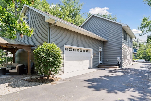 4312 France Ave S, Edina, MN 55410 - view of property exterior featuring an outdoor hangout area, an attached garage, concrete driveway, and a gazebo