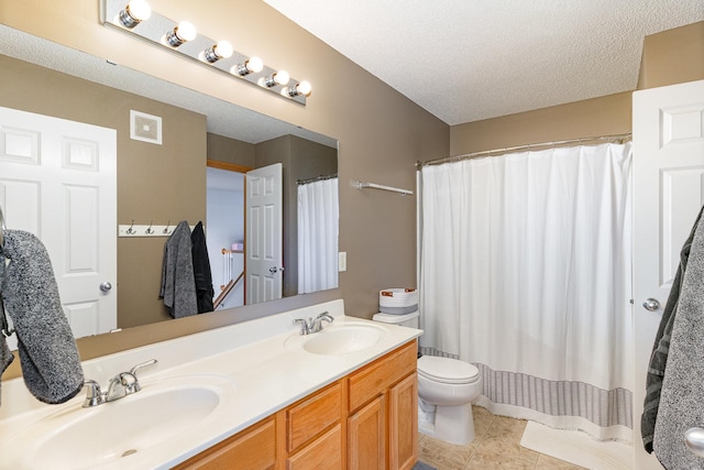 14399 Banyan Ln, Rosemount, MN 55068 - bathroom featuring double vanity, tile patterned floors, and a textured ceiling