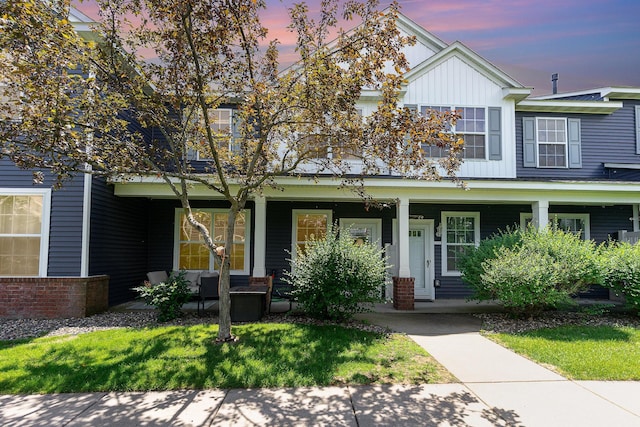 14399 Banyan Ln, Rosemount, MN 55068 - view of front facade with board and batten siding, a porch, and a front lawn