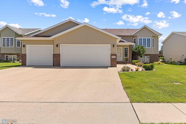 4515 Westport Pkwy, Fargo, ND 58078 - tri-level home featuring brick siding, a garage, driveway, and a front yard
