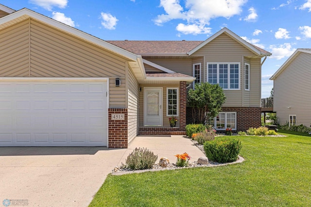 4515 Westport Pkwy, Fargo, ND 58078 - view of front facade featuring brick siding, a front yard, driveway, an attached garage, and a shingled roof