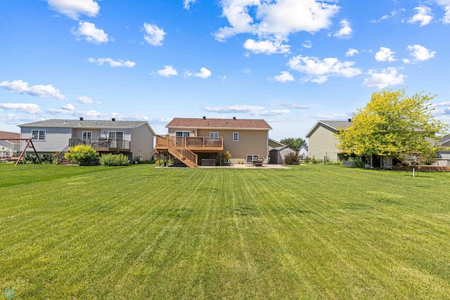 4515 Westport Pkwy, Fargo, ND 58078 - rear view of house with a deck, stairway, and a lawn
