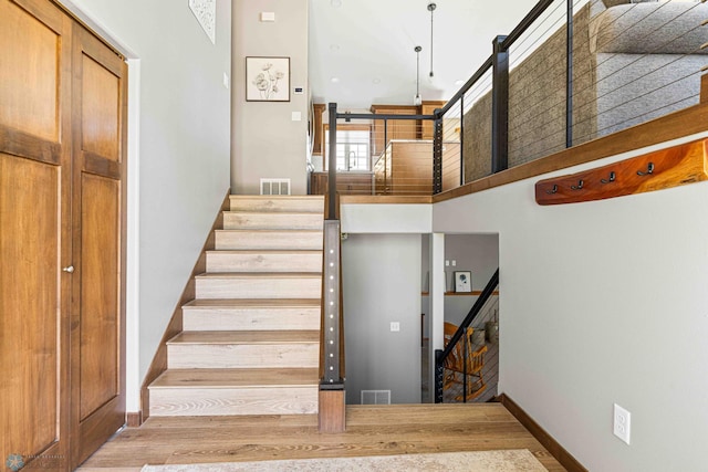 4515 Westport Pkwy, Fargo, ND 58078 - staircase with wood finished floors and a high ceiling
