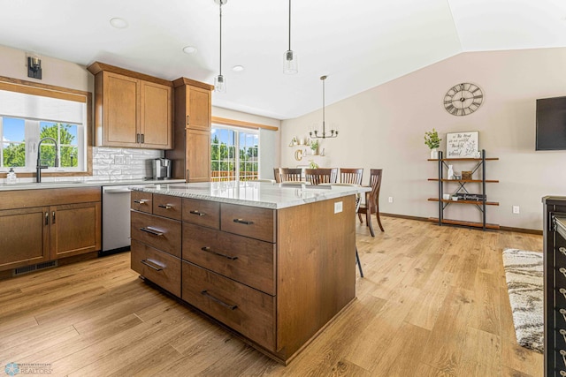 4515 Westport Pkwy, Fargo, ND 58078 - kitchen with lofted ceiling, dishwasher, light wood-style flooring, pendant lighting, and a kitchen island