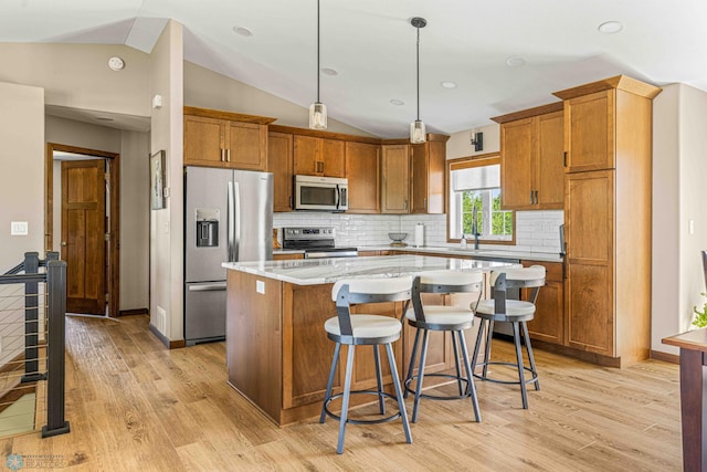 4515 Westport Pkwy, Fargo, ND 58078 - kitchen with appliances with stainless steel finishes, lofted ceiling, light wood-style floors, and brown cabinets