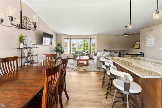 4515 Westport Pkwy, Fargo, ND 58078 - dining space featuring lofted ceiling, light wood-type flooring, a chandelier, and ceiling fan