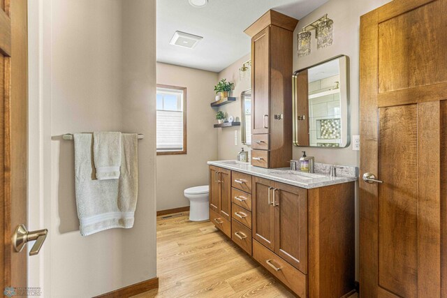 4515 Westport Pkwy, Fargo, ND 58078 - full bathroom featuring double vanity and wood finished floors