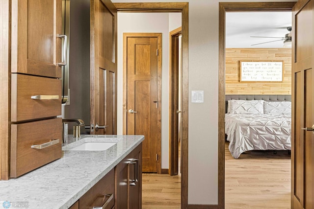 4515 Westport Pkwy, Fargo, ND 58078 - bathroom with vanity, wood finished floors, a ceiling fan, and wooden walls