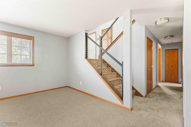 4515 Westport Pkwy, Fargo, ND 58078 - stairs with carpet flooring and a textured ceiling