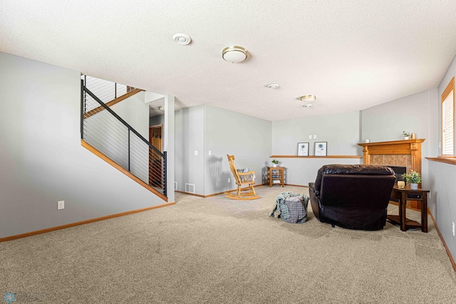 4515 Westport Pkwy, Fargo, ND 58078 - living area with carpet floors, stairs, a tile fireplace, and a textured ceiling