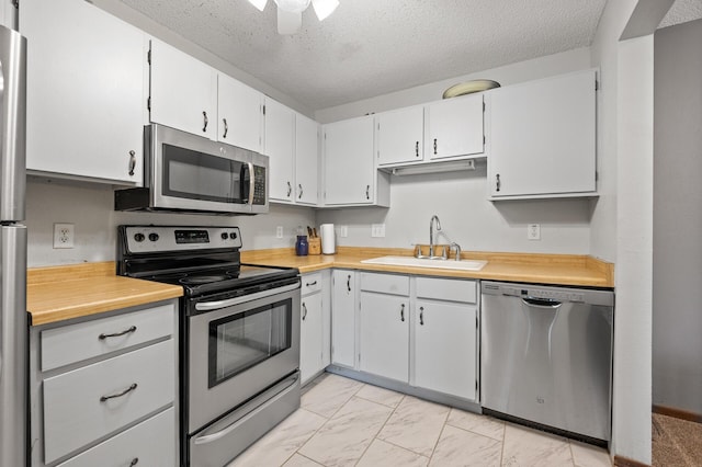 3850 Plymouth Blvd Unit 204, Plymouth, MN 55446 - kitchen featuring appliances with stainless steel finishes, light countertops, light marble finish flooring, a textured ceiling, and ceiling fan