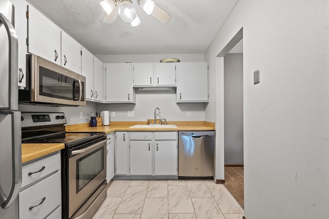 3850 Plymouth Blvd Unit 204, Plymouth, MN 55446 - kitchen with appliances with stainless steel finishes, light countertops, a textured ceiling, ceiling fan, and light marble finish floors