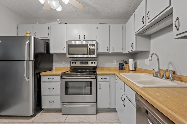3850 Plymouth Blvd Unit 204, Plymouth, MN 55446 - kitchen featuring stainless steel appliances, light marble finish flooring, light countertops, a textured ceiling, and a ceiling fan