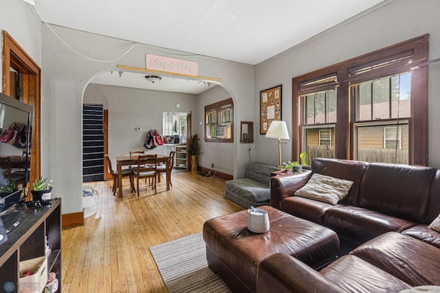 1329 12th St N, Fargo, ND 58102 - living area with arched walkways, light wood finished floors, and stairway