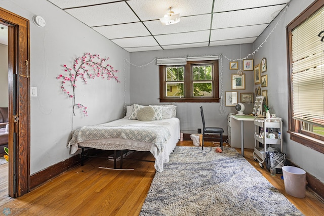 1329 12th St N, Fargo, ND 58102 - bedroom featuring a drop ceiling and wood finished floors