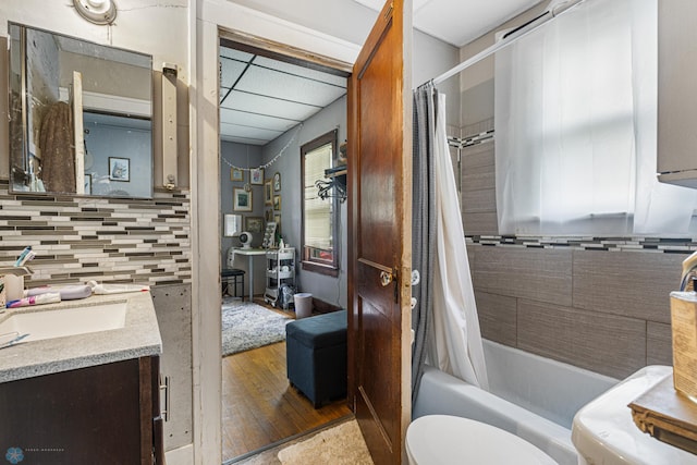 1329 12th St N, Fargo, ND 58102 - full bath with vanity, shower / bath combo with shower curtain, wood finished floors, and tasteful backsplash