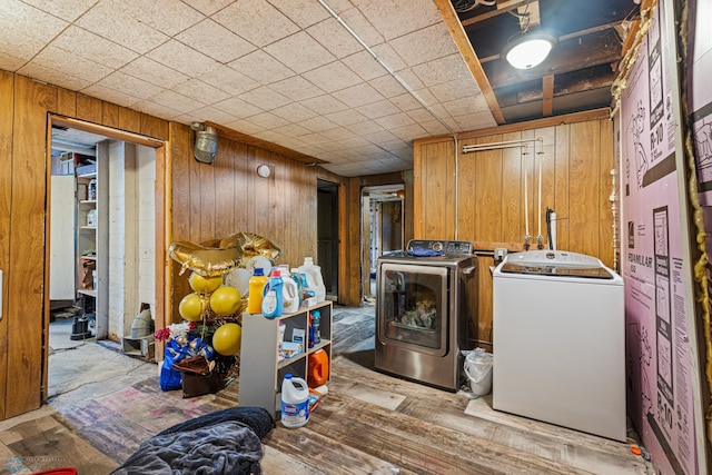 1329 12th St N, Fargo, ND 58102 - laundry area featuring washer and clothes dryer and wood walls