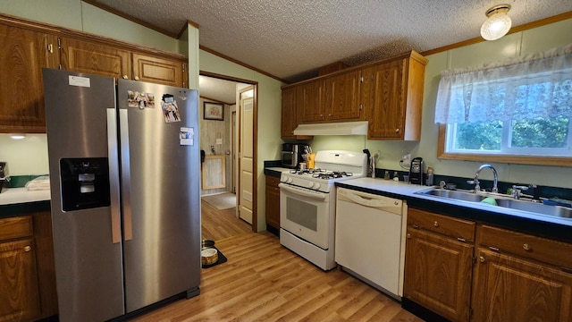 3665 Fox Ln, Pequot Lakes, MN 56472 - kitchen featuring white appliances, lofted ceiling, crown molding, light wood-type flooring, and under cabinet range hood