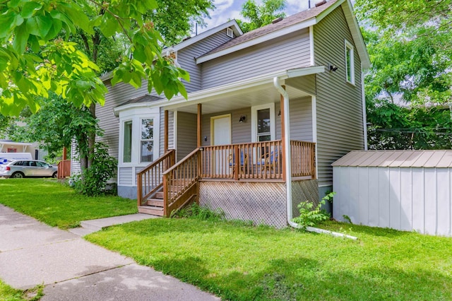 2700 Aldrich Ave N, Minneapolis, MN 55411 - view of front of home featuring a front lawn, covered porch, and a storage shed