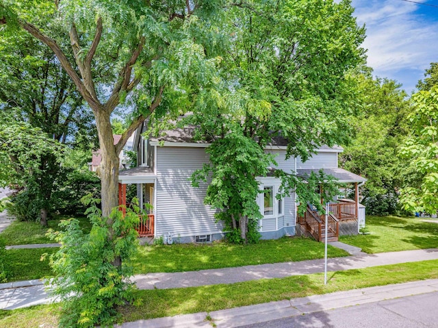 2700 Aldrich Ave N, Minneapolis, MN 55411 - obstructed view of property with a front yard, a wooden deck, and roof with shingles