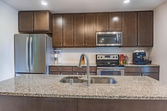 2700 Aldrich Ave N, Minneapolis, MN 55411 - kitchen featuring appliances with stainless steel finishes, dark brown cabinets, recessed lighting, and tasteful backsplash