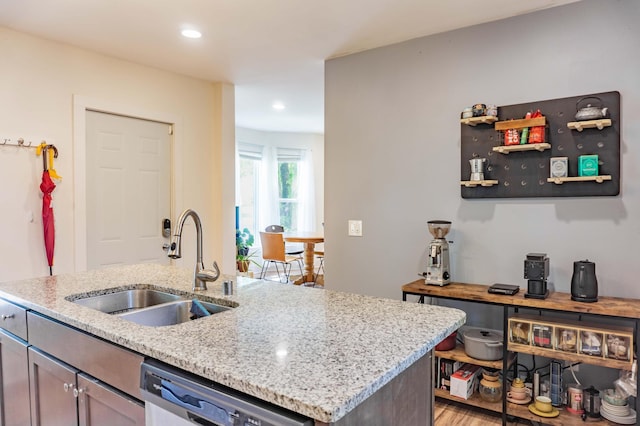 2700 Aldrich Ave N, Minneapolis, MN 55411 - kitchen featuring dishwasher, light wood-type flooring, light stone countertops, recessed lighting, and a kitchen island with sink