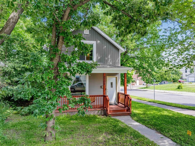2700 Aldrich Ave N, Minneapolis, MN 55411 - view of front of property with a porch, a front lawn, and board and batten siding