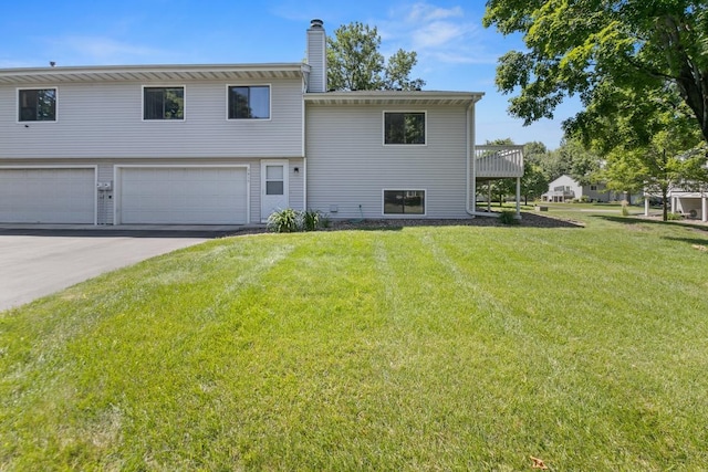 3615 156th St W, Rosemount, MN 55068 - back of property with an attached garage, a yard, a chimney, and driveway