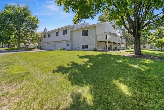 3615 156th St W, Rosemount, MN 55068 - rear view of property featuring an attached garage, a yard, asphalt driveway, and a chimney