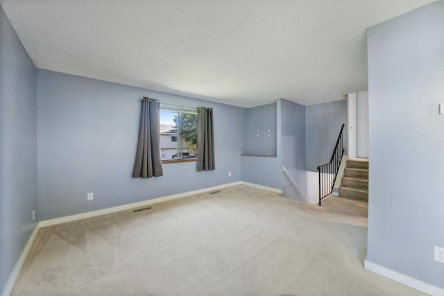 3615 156th St W, Rosemount, MN 55068 - carpeted empty room featuring a textured ceiling and stairs