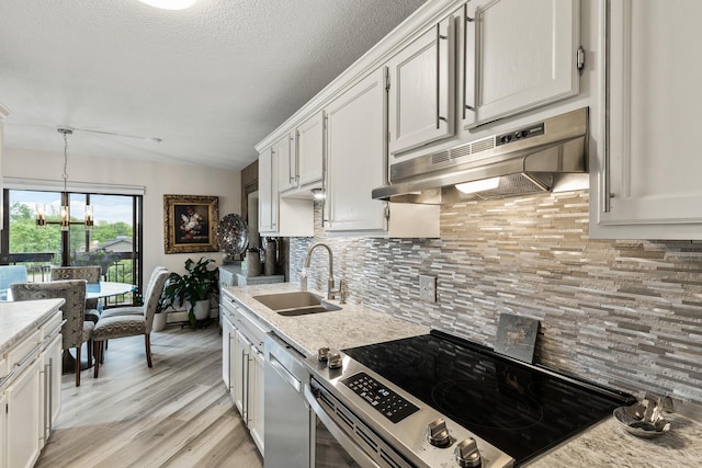 6615 Lake Shore Dr S Unit 314, Richfield, MN 55423 - kitchen featuring appliances with stainless steel finishes, under cabinet range hood, decorative backsplash, white cabinets, and lofted ceiling