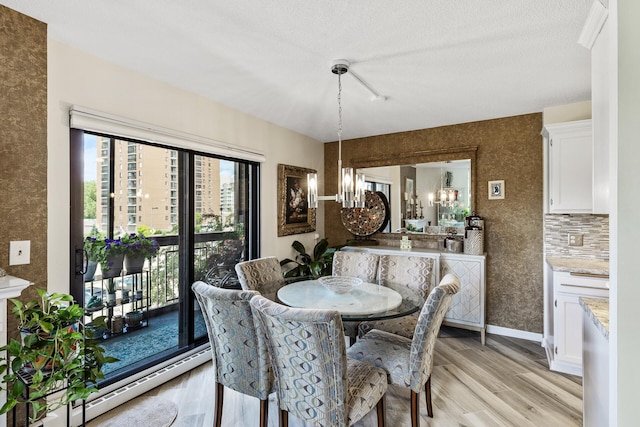 6615 Lake Shore Dr S Unit 314, Richfield, MN 55423 - dining space with light wood-style flooring and a chandelier