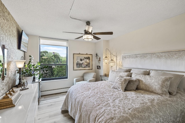 6615 Lake Shore Dr S Unit 314, Richfield, MN 55423 - bedroom with a baseboard heating unit, wood finished floors, a textured ceiling, and ceiling fan