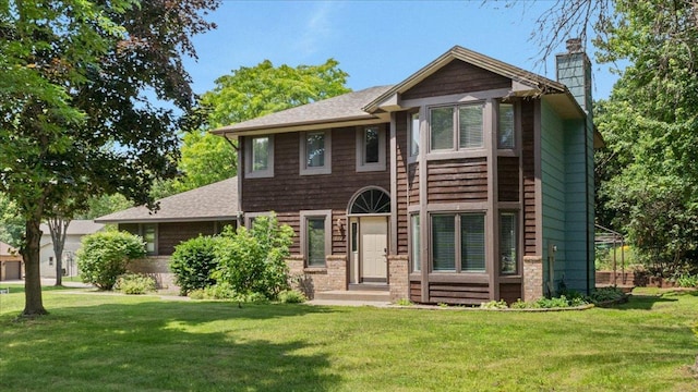 12720 Ibis St NW, Coon Rapids, MN 55448 - view of front of property with a chimney, a front yard, and a shingled roof