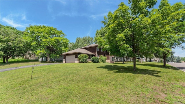 12720 Ibis St NW, Coon Rapids, MN 55448 - view of front of house with asphalt driveway, a garage, and a front lawn