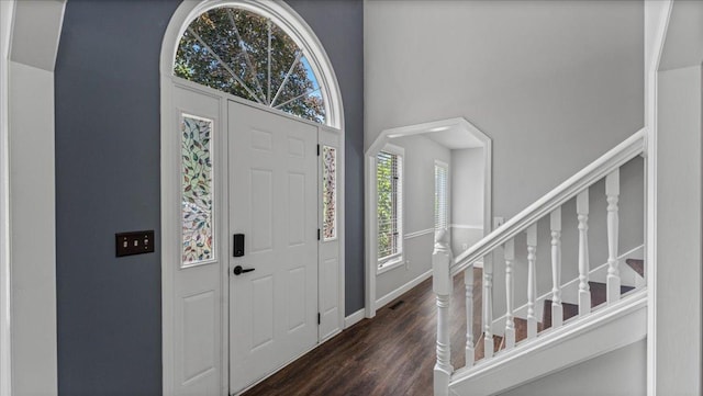 12720 Ibis St NW, Coon Rapids, MN 55448 - foyer entrance with dark wood-style floors, stairway, and a towering ceiling