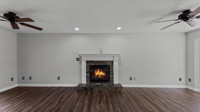 12720 Ibis St NW, Coon Rapids, MN 55448 - unfurnished living room with wood finished floors, a tiled fireplace, recessed lighting, ceiling fan, and a textured ceiling