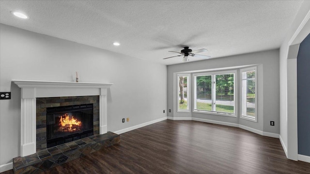12720 Ibis St NW, Coon Rapids, MN 55448 - unfurnished living room with wood finished floors, a textured ceiling, a tile fireplace, a ceiling fan, and recessed lighting