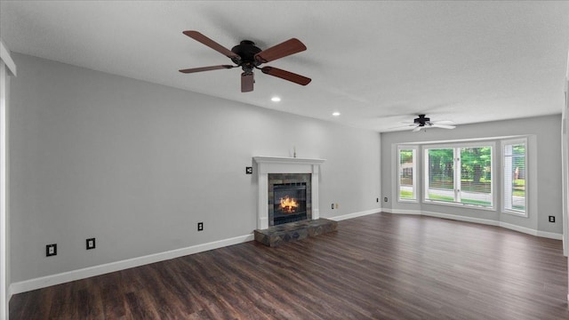 12720 Ibis St NW, Coon Rapids, MN 55448 - unfurnished living room featuring dark wood-style flooring, ceiling fan, a fireplace, and recessed lighting