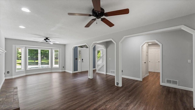 12720 Ibis St NW, Coon Rapids, MN 55448 - unfurnished living room featuring arched walkways, ceiling fan, dark wood-style floors, recessed lighting, and a textured ceiling