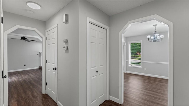 12720 Ibis St NW, Coon Rapids, MN 55448 - corridor featuring dark wood-style floors, a chandelier, and arched walkways