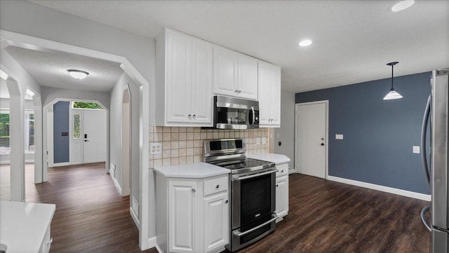 12720 Ibis St NW, Coon Rapids, MN 55448 - kitchen featuring stainless steel appliances, light countertops, dark wood-type flooring, backsplash, and white cabinets
