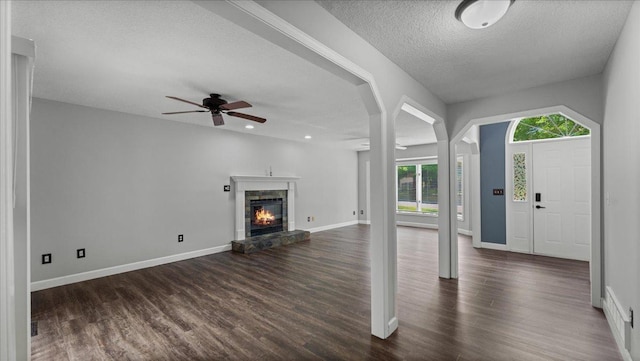 12720 Ibis St NW, Coon Rapids, MN 55448 - foyer entrance featuring dark wood finished floors, ceiling fan, a stone fireplace, a textured ceiling, and recessed lighting